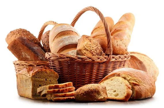 Basket of assorted breads and sliced loaves