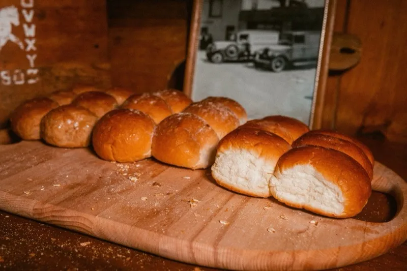 Golden dinner rolls on a wooden board