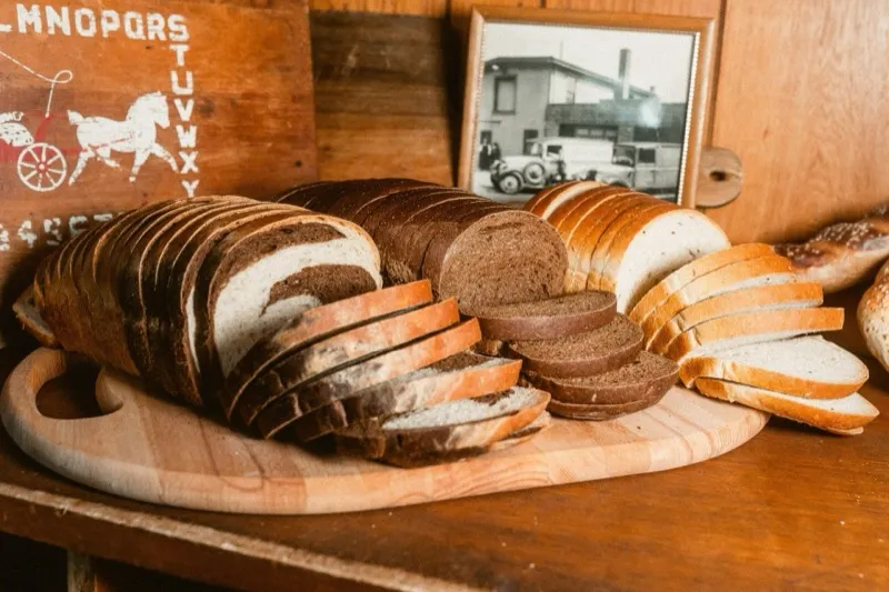 Sliced rye and white loaves on a wooden board